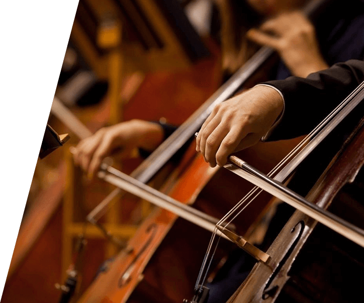 A person playing the cello in a orchestra.